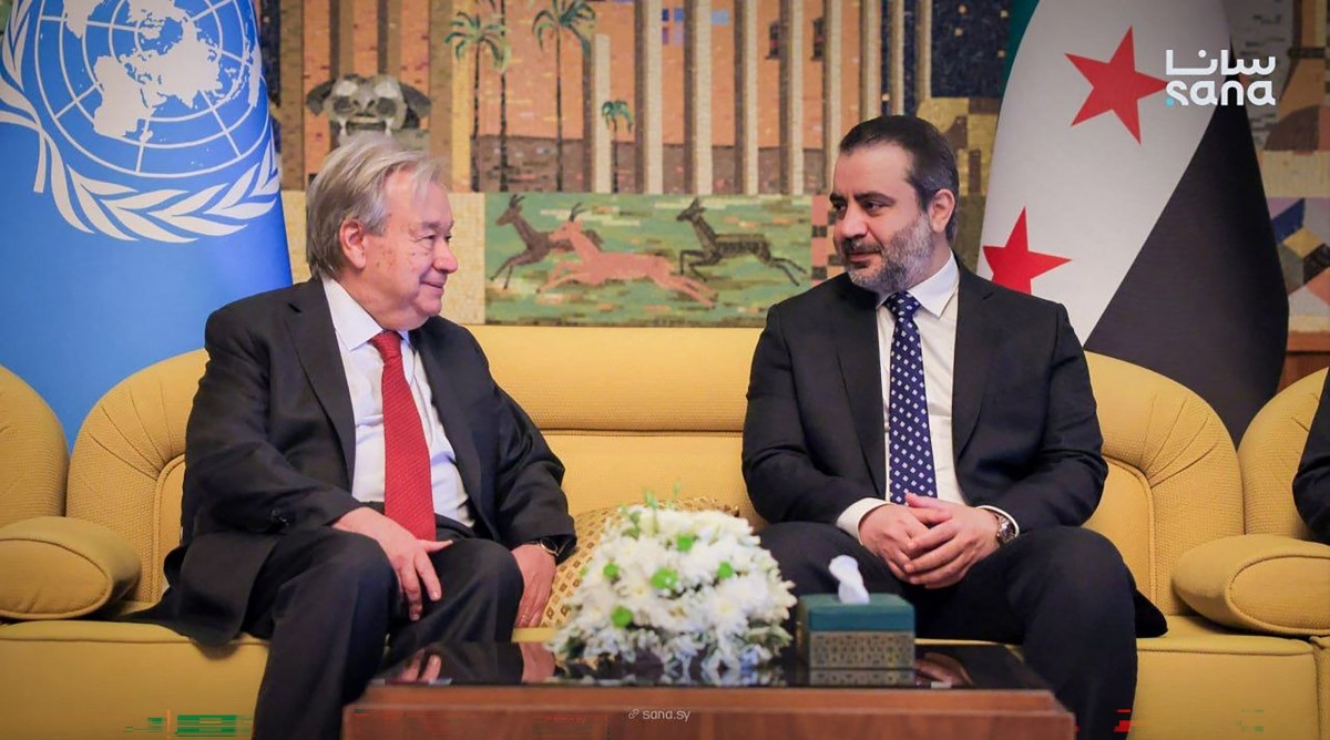 This handout picture taken and released by the official Syrian Arab News Agency (SANA) on July 25, 2026 shows Syria's Foreign Affairs Minister Asaad al-Shaibani (R) receiving UN Secretary-General Antonio Guterres at Damascus International Airport in Damascus.  (Photo by SANA / AFP)  
