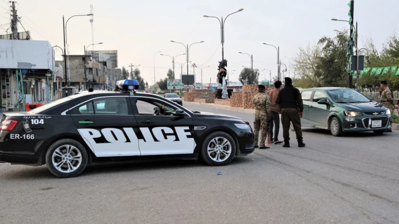 Police officers inspect a civilian vehicle at a street checkpoint in Kirkuk. Photo: Channel8
