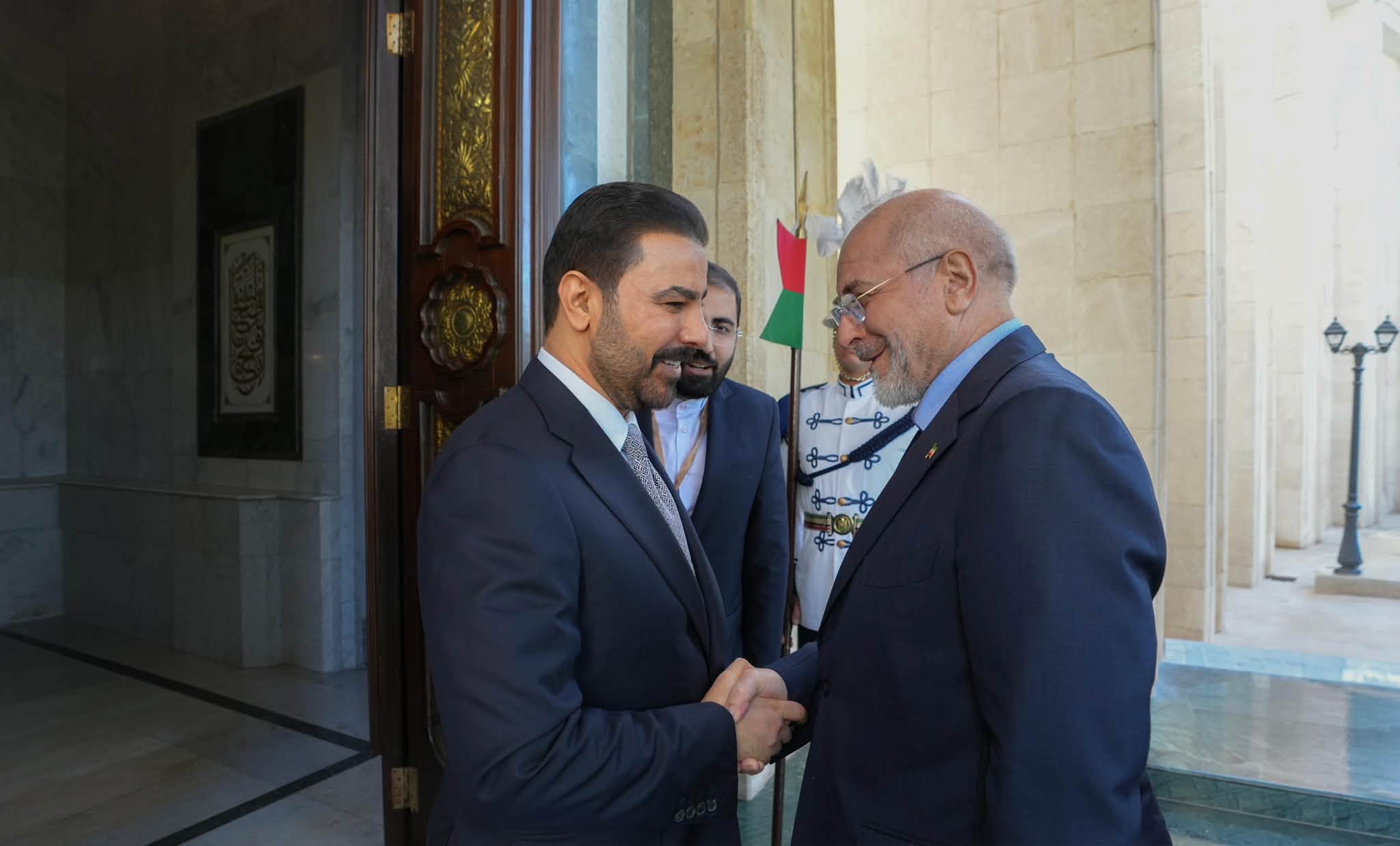 Iraqi Federal Prime Minister Ali Faleh al-Zaidi (left) shakes hands with Mohammad Bagher Ghalibaf (right), Speaker of the Islamic Consultative Assembly of Iran, during an official reception in Baghdad.