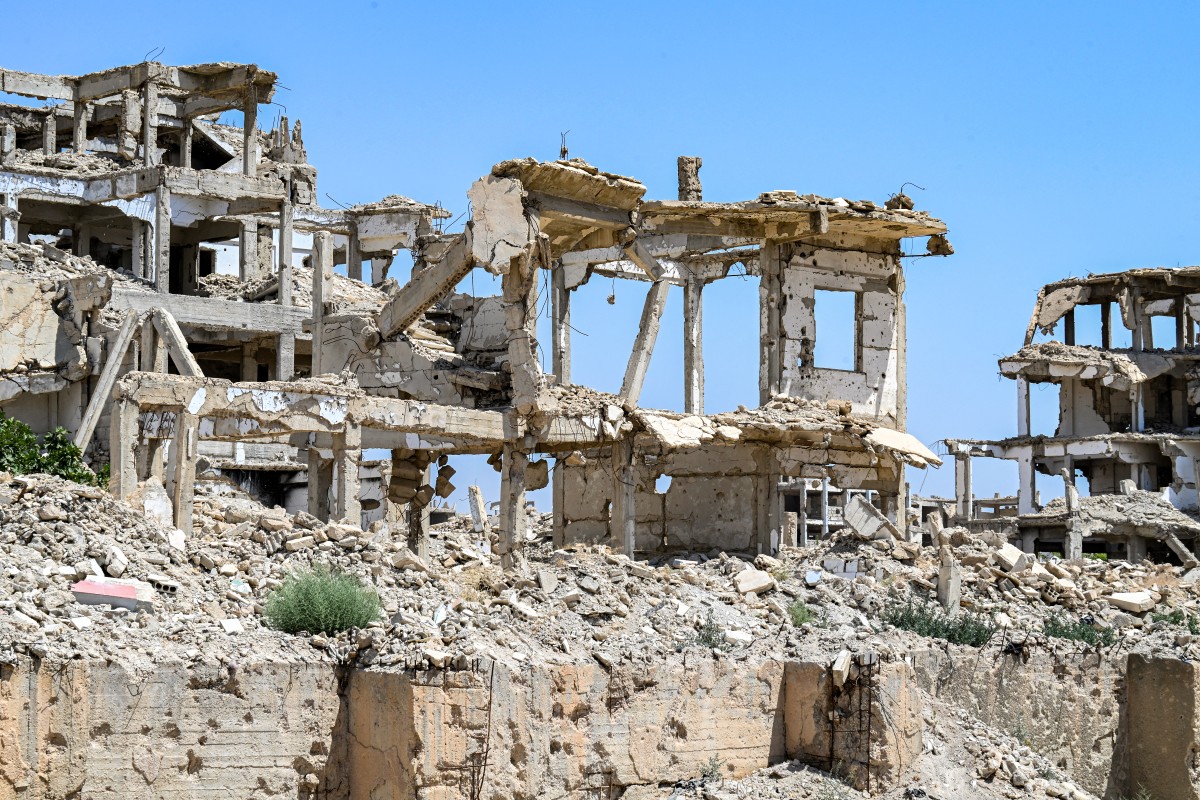 Heavily-damaged and destroyed buildings are pictured in the Jobar suburb northeast of Damascus on August 12, 2026. (Photo by LOUAI BESHARA / AFP)