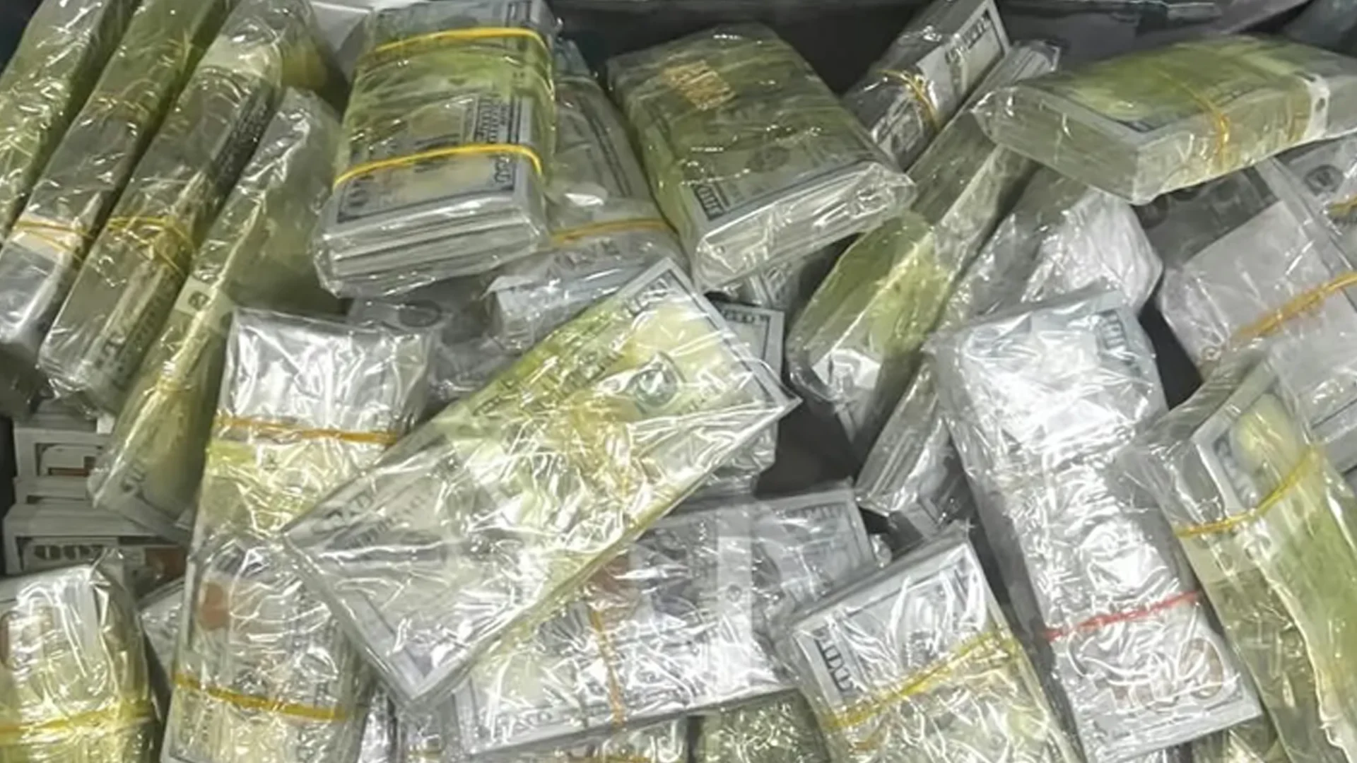 SEIZED ASSETS: Plastic-wrapped stacks of cash recovered by the Federal Integrity Commission during a raid on properties belonging to Khalid Ghazai Attiya, Iraq's Undersecretary of Electricity for Transmission and Distribution Affairs, in Baghdad.