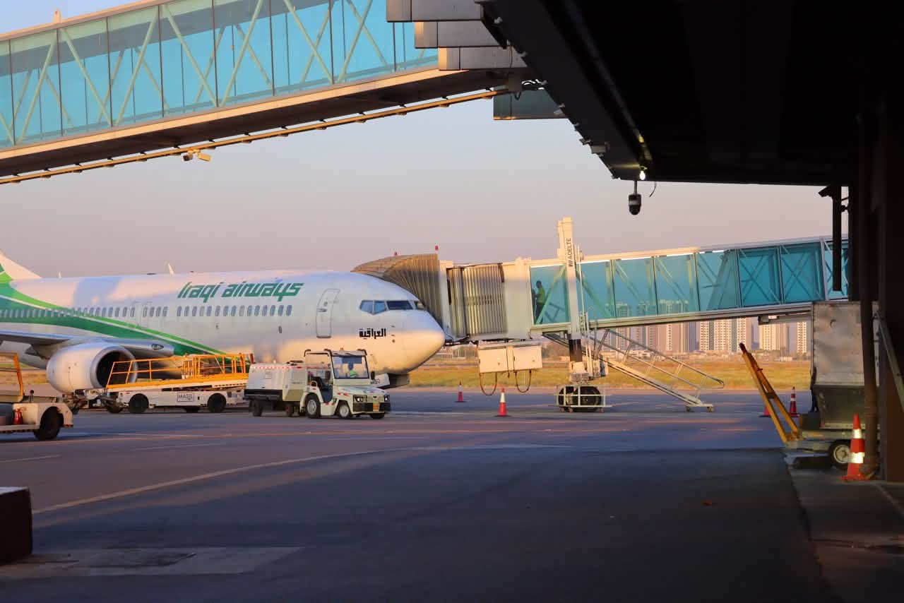 
An Iraqi Airways Boeing 737 MAX aircraft sits parked at a passenger boarding bridge at Baghdad International Airport. Photo: Baghdad International Airport


