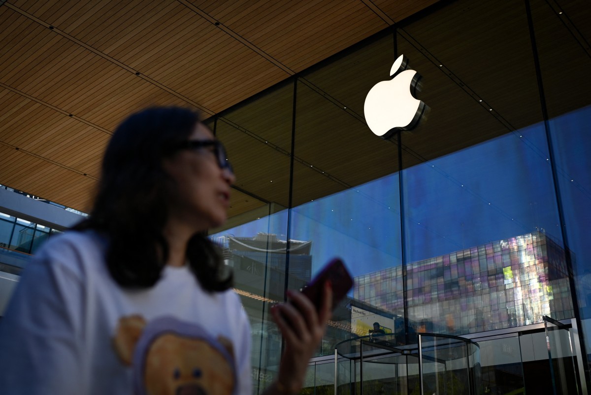 A woman walks past an Apple store in Beijing on August 31, 2026. (Photo by WANG Zhao / AFP)