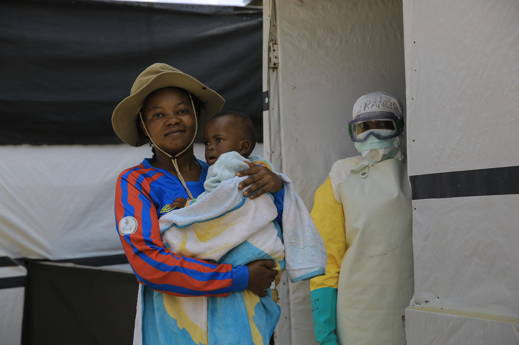 One-year-old Kavugho Mayolo Latifa, whose mother died of Ebola, is carried by her sister Leandrine Kavira, after recovering from the virus, during a release ceremony inside a treatment center in Beni, North Kivu province, eastern Congo, Saturday, Sept. 26, 2026. (AP Photo/Sebastien Kitsa Musayi)