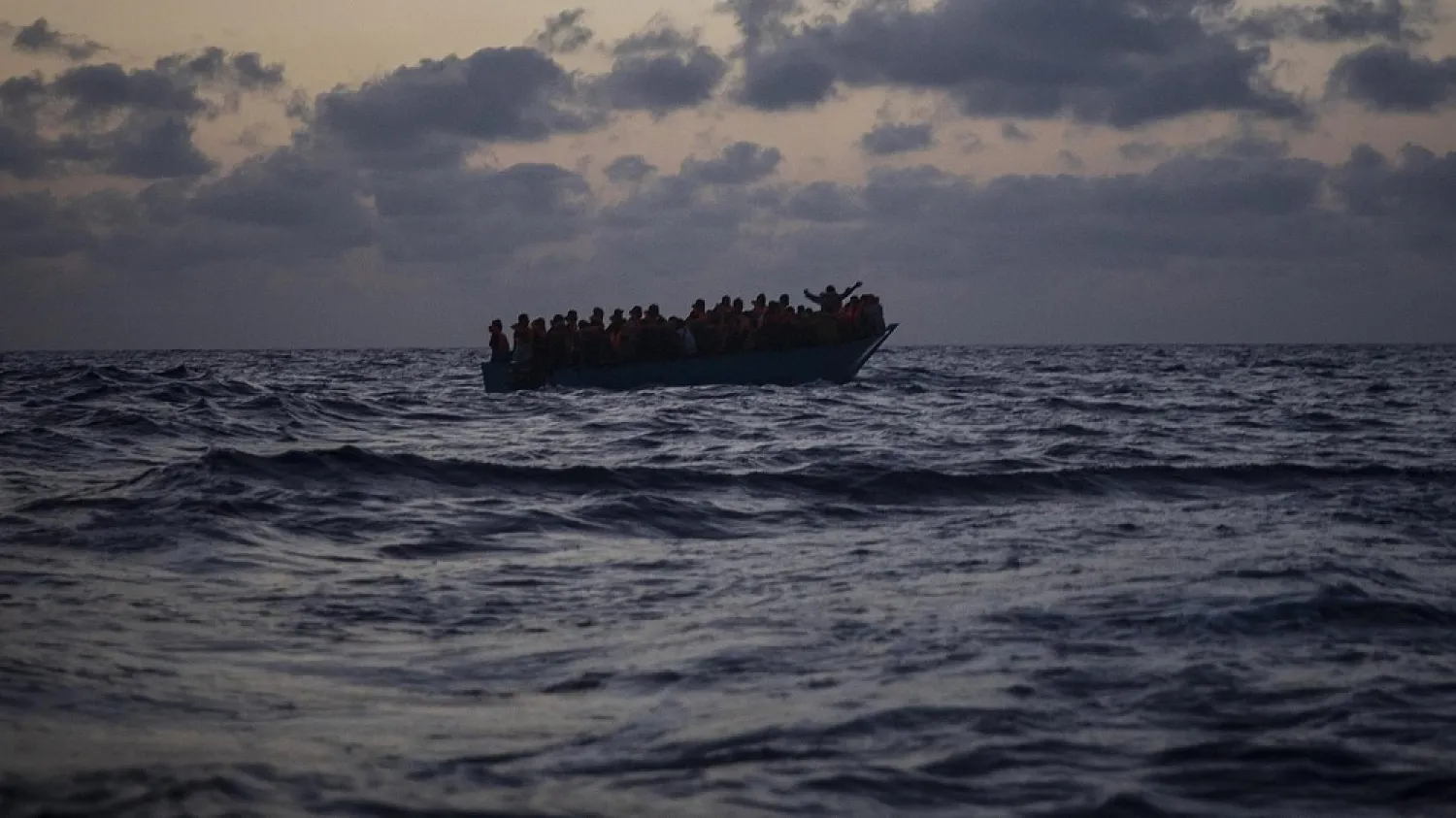 A crowded boat packed with migrants navigates the Mediterranean Sea. Photo: AP 







