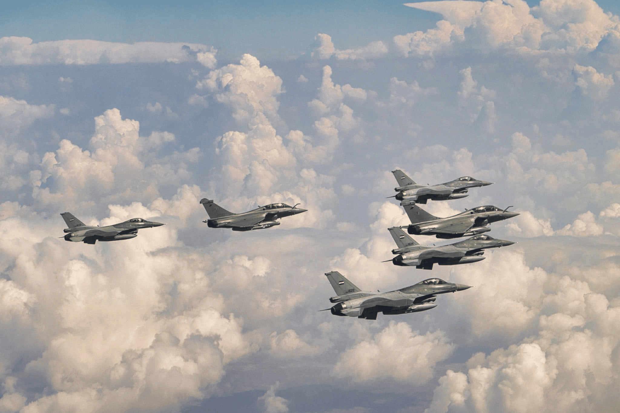 Iraqi Air Force F-16 fighter jets fly in formation during a combat flight mission.