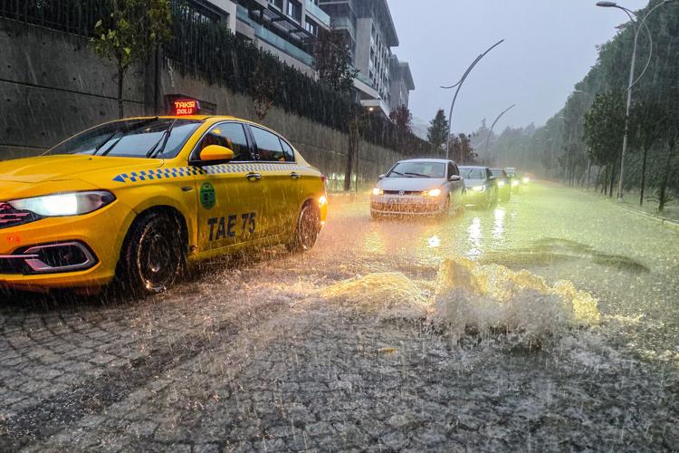 Vehicles drive along a partially flooded road during a heavy rain in Istanbul, Turkey, Wednesday, Oct. 14, 2026. (Omer Hamza Yildiz/DIA Photo via AP)
