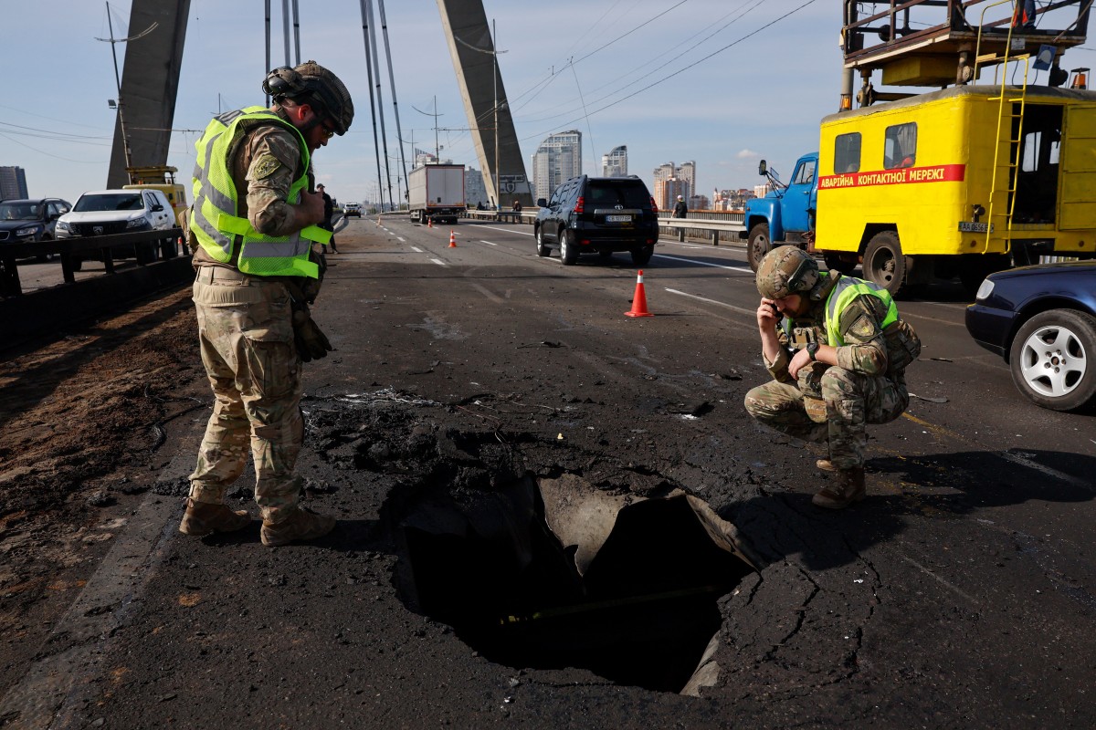 Russia struck another major bridge in Kyiv on October 4, soon after Germany's chancellor arrived on a surprise visit to show European support in the face of an upsurge in attacks. (Photo by Mykola TYMCHENKO / AFP)