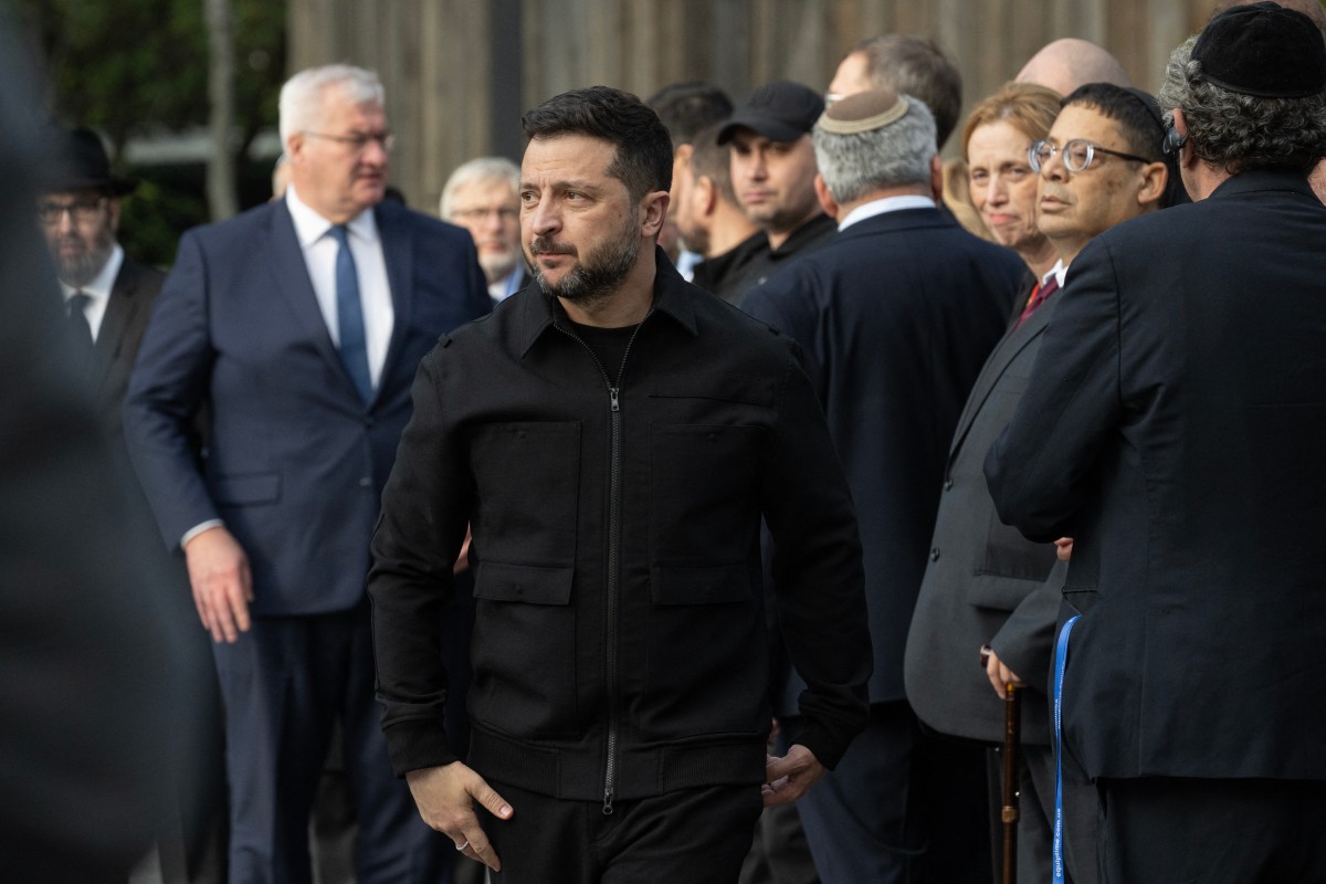 President of Ukraine Volodymyr Zelensky looks on during a memorial ceremony at the Babyn Yar National Historical and Memorial Reserve to honor the victims of the mass execution of civilians by the Nazis during World War II, in Kyiv on October 6, 2026, amid the Russian invasion of Ukraine. (Photo by Genya SAVILOV / AFP)