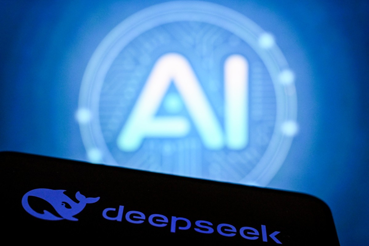 A photo taken on October 12, 2026 shows AI letters on a laptop screen next to the logo of China's Deepseek AI application (bottom) on a smartphone screen in Frankfurt am Main, western Germany. (Photo by Kirill KUDRYAVTSEV / AFP)