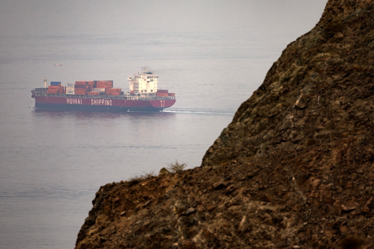 The Chinese-flagged container shipping vessel Hui Fa transits the Gulf of Oman off the coast of Khor Fakkan in the emirate of Sharjah in the east of the UAE on October 13, 2026. The International Monetary Fund (IMF) has sharply cut growth forecasts for the Middle East and Central Asia in 2026, citing "a longer closure of the Strait of Hormuz, compared with the baseline assumptions in the April" report, and predicting a major rebound in 2027 based on the expected reopening of the waterway. (Photo by AFP)