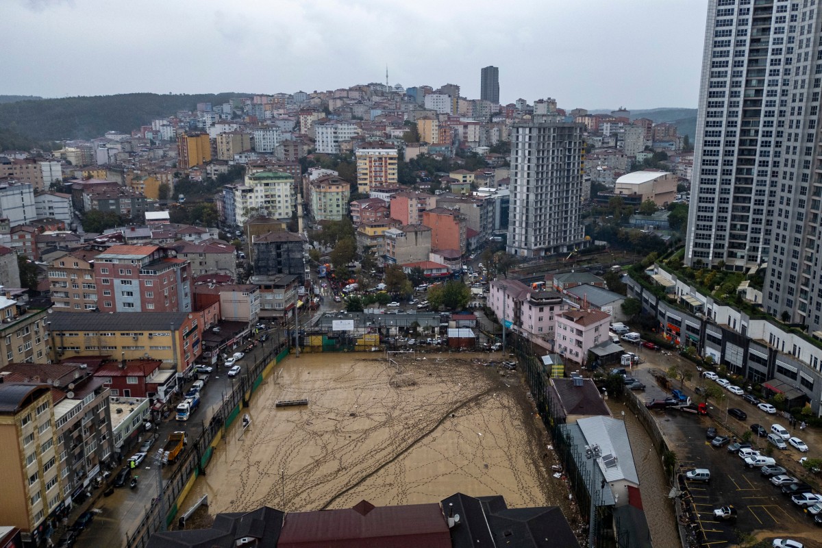 This aerial photograph shows a football pitch covered with mud and debris, one day after flooding caused by what officials said was the heaviest rainfall in the city since records began more than 80 years ago, in the Ayazaga district of Istanbul on October 16, 2026. (Photo by Yasin AKGUL / AFP)