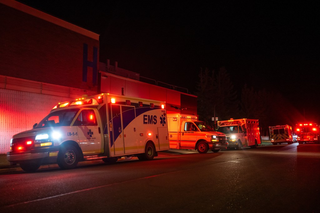 Emergency crews and military personnel gather at the Wainwright Health Centre as injured military members are treated after a fire at Canadian Forces Base Wainwright, outside of Wainwright, Alberta Saturday, Oct. 17, 2026. (John Ulan/The Canadian Press via AP)
