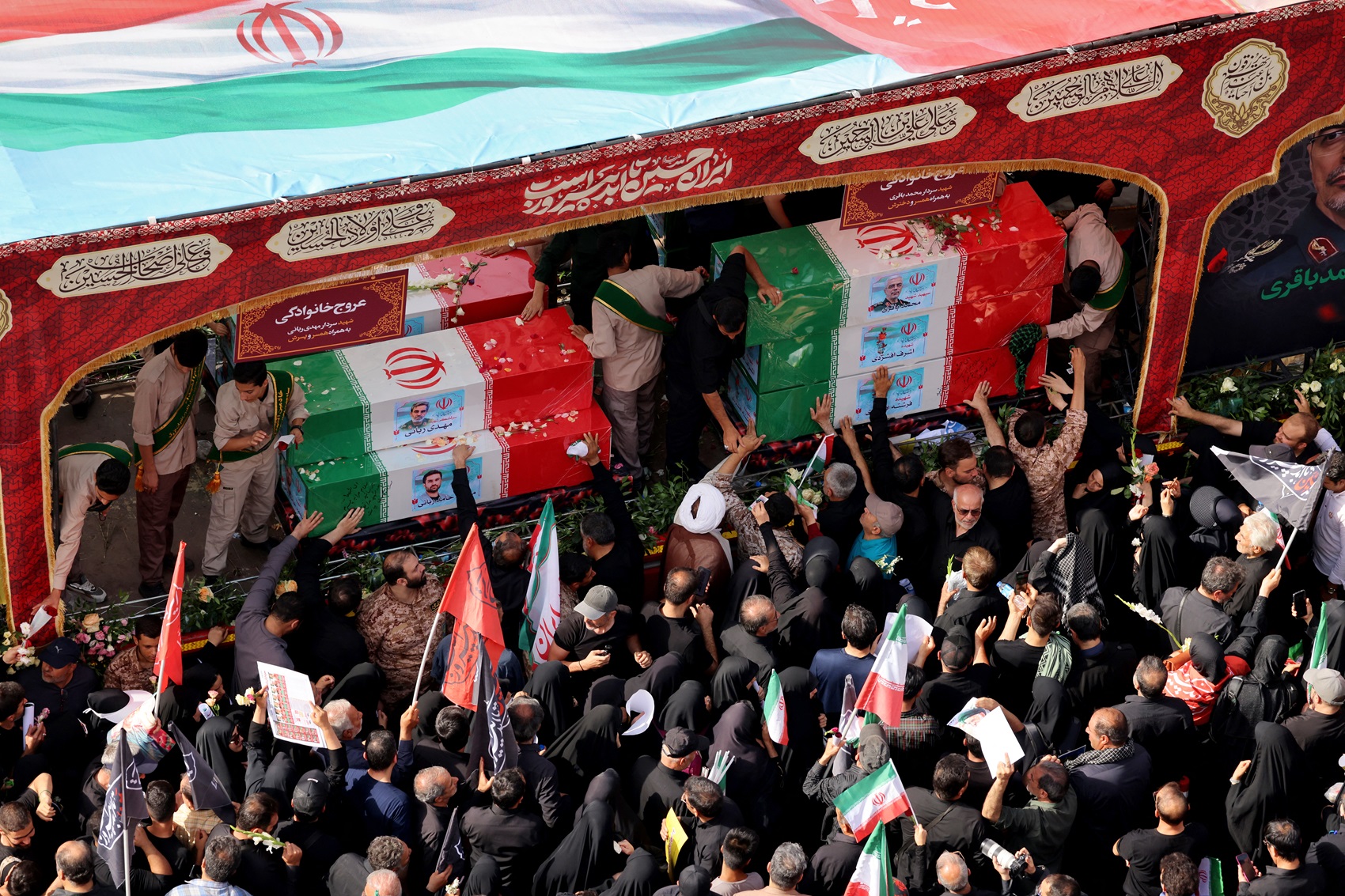 Mourners attend the funeral procession of Iranian military commanders and scientists killed during Israeli strikes at Enghelab (Revolution) Square in the capital Tehran on June 28, 2025. Iran began a state funeral service on June 28 for around 60 people, including its military commanders, killed in its war with Israel, after Tehran's top diplomat condemned Donald Trump's comments on supreme leader Ali Khamenei as "unacceptable". (Photo by ATTA KENARE / AFP)